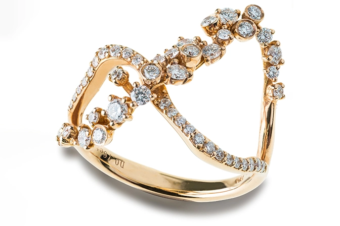 Diamond Gold Platinum Jewelry A twisted gold ring adorned with sparkling diamonds in various sizes, showcasing an elegant and unique design